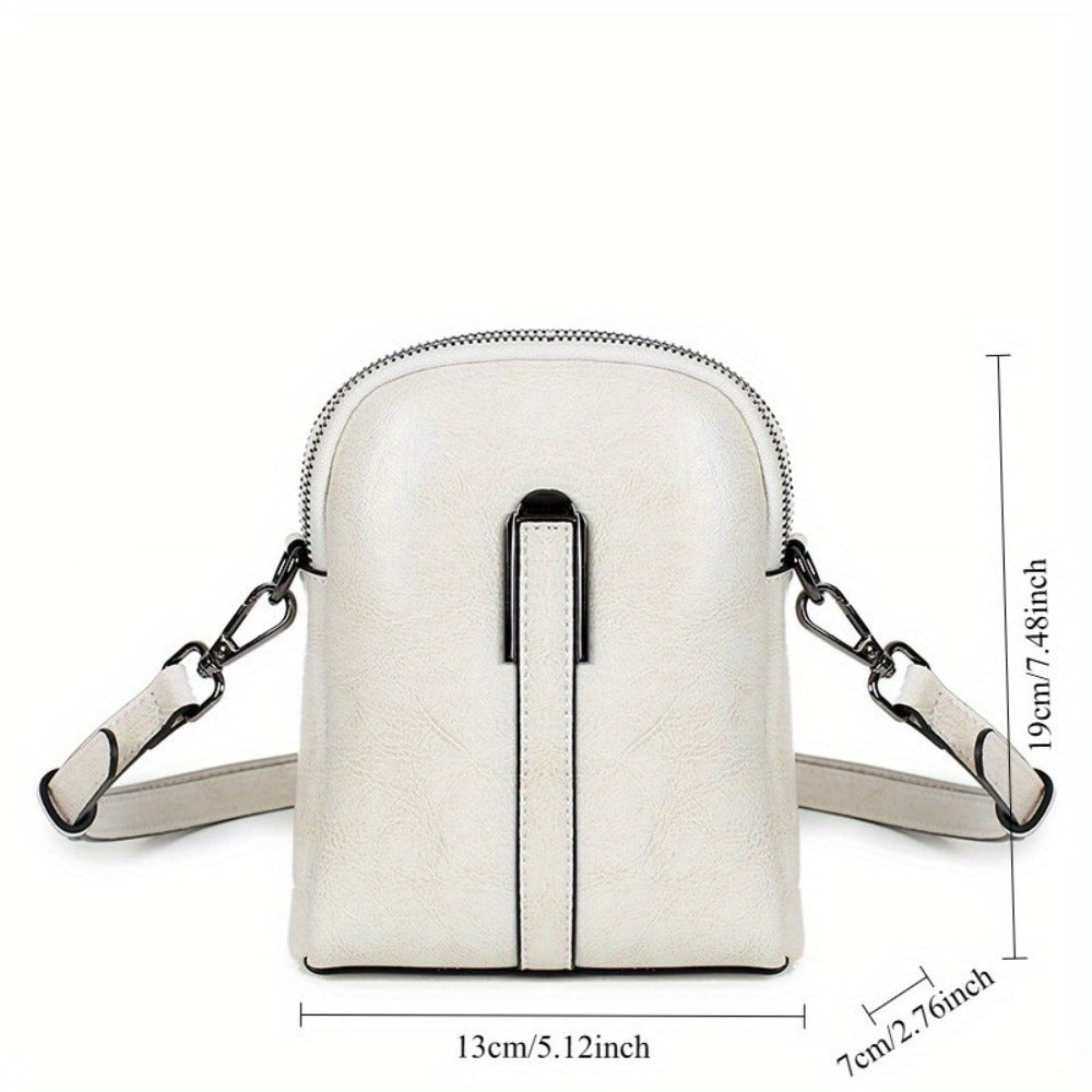 A Crossbody Bag Made of Authentic Leather for Women, Featuring a Small Size, an Adjustable Chain Strap, a Zip Closure, And a Stylish Look. Perfect for Both Everyday Use And Formal Events, Offered in Shades of Coffee Brown, Beige, And Black