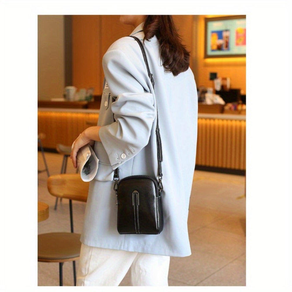A Crossbody Bag Made of Authentic Leather for Women, Featuring a Small Size, an Adjustable Chain Strap, a Zip Closure, And a Stylish Look. Perfect for Both Everyday Use And Formal Events, Offered in Shades of Coffee Brown, Beige, And Black