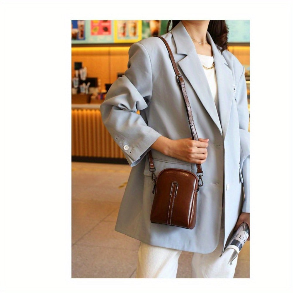 A Crossbody Bag Made of Authentic Leather for Women, Featuring a Small Size, an Adjustable Chain Strap, a Zip Closure, And a Stylish Look. Perfect for Both Everyday Use And Formal Events, Offered in Shades of Coffee Brown, Beige, And Black