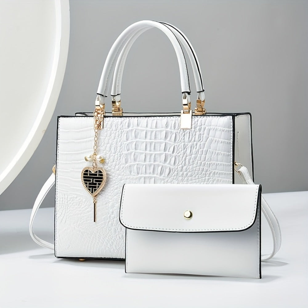 A Women'S Bag Featuring a Crocodile Print Texture, Designed for Both Hand And Crossbody Use, with a Heart-Shaped Hanging Decoration As a Finishing Touch