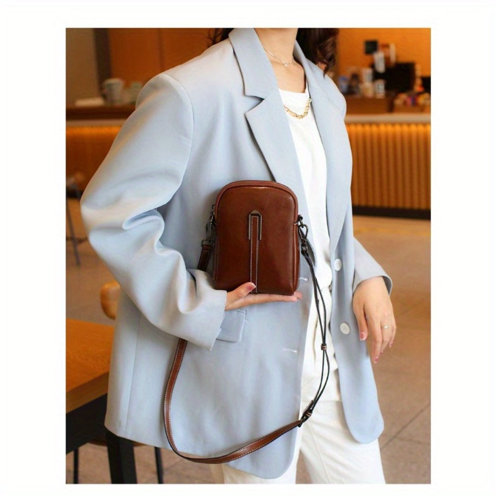 A Crossbody Bag Made of Authentic Leather for Women, Featuring a Small Size, an Adjustable Chain Strap, a Zip Closure, And a Stylish Look. Perfect for Both Everyday Use And Formal Events, Offered in Shades of Coffee Brown, Beige, And Black