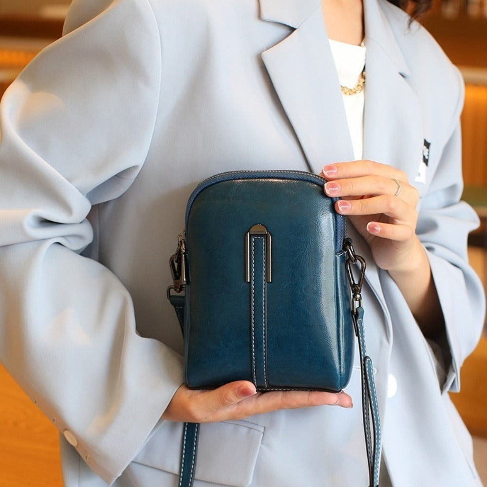 A Crossbody Bag Made of Authentic Leather for Women, Featuring a Small Size, an Adjustable Chain Strap, a Zip Closure, And a Stylish Look. Perfect for Both Everyday Use And Formal Events, Offered in Shades of Coffee Brown, Beige, And Black