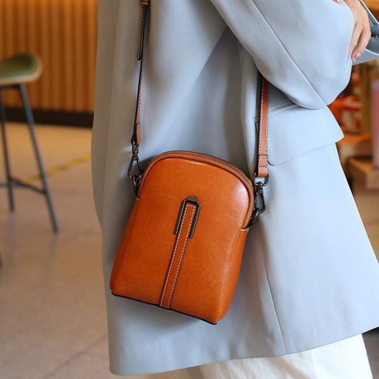 A Crossbody Bag Made of Authentic Leather for Women, Featuring a Small Size, an Adjustable Chain Strap, a Zip Closure, And a Stylish Look. Perfect for Both Everyday Use And Formal Events, Offered in Shades of Coffee Brown, Beige, And Black